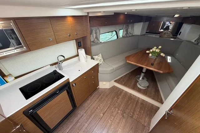Slide: The Image of Luxurious interior of 2016 Cruisers Yachts 390 Express Coupe with kitchen and seating area. - 16
