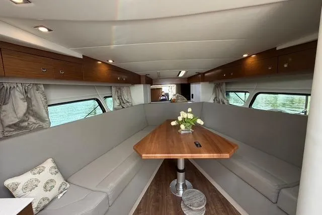 Slide: The Image of Interior of 2016 Cruisers Yachts 390 Express Coupe with elegant seating and wooden table. - 18