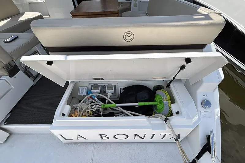 Slide: The Image of 2016 Cruisers Yachts 390 Express Coupe storage compartment with cleaning supplies and equipment. - 2