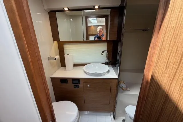 Slide: The Image of 2016 Cruisers Yachts 390 Express Coupe bathroom with modern fixtures and wood accents. - 21
