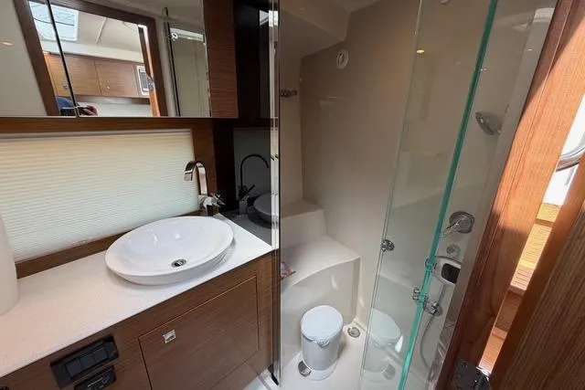 Slide: The Image of Luxurious bathroom in 2016 Cruisers Yachts 390 Express Coupe with modern fixtures and glass shower. - 22