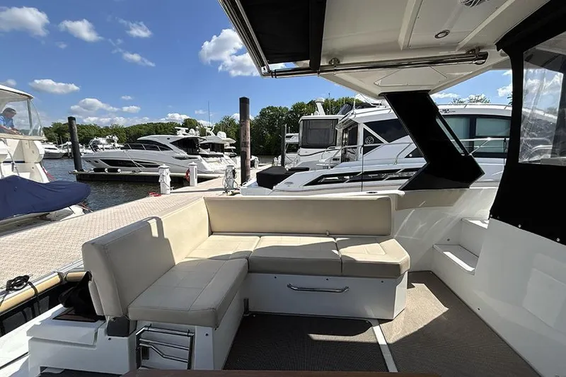 Slide: The Image of 2016 Cruisers Yachts 390 Express Coupe interior with docked boats in background. - 4