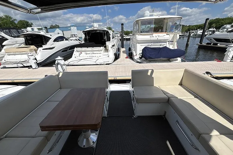 Slide: The Image of 2016 Cruisers Yachts 390 Express Coupe interior with docked boats in marina background. - 6