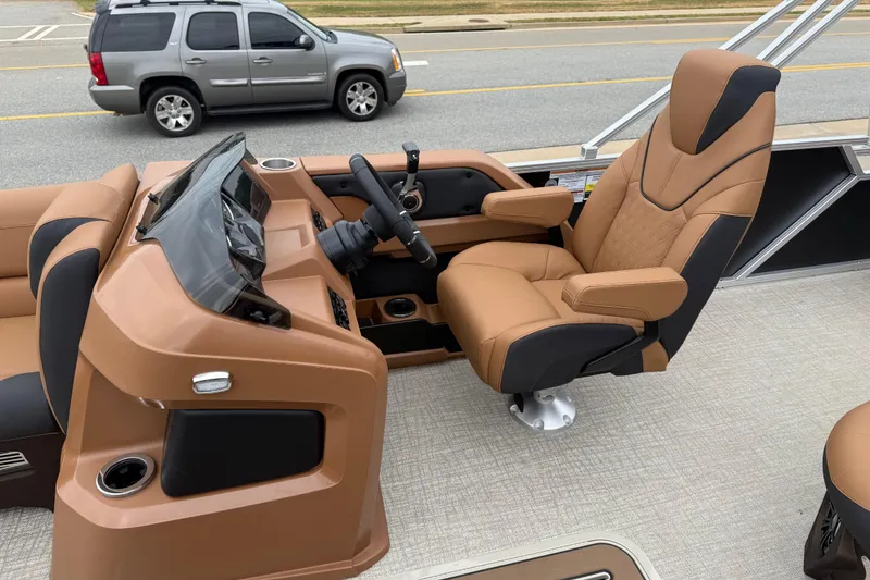 Slide: The Image of Captain's chair and console of 2026 Avalon LSZ Rear Fish boat, featuring tan upholstery. - 12