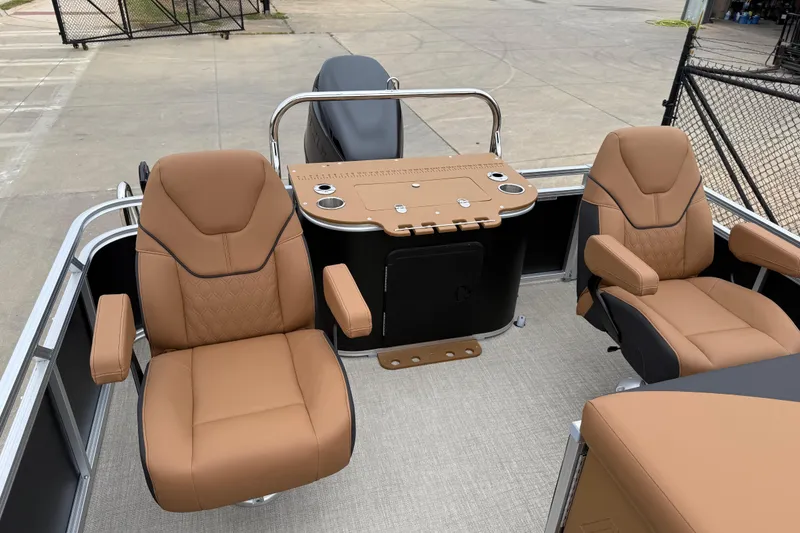 Slide: The Image of Luxurious seating on 2026 Avalon LSZ Rear Fish boat, featuring tan leather chairs and fishing station. - 16