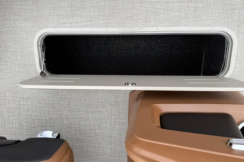Slide: The Image of Open storage compartment on 2026 Avalon LSZ Rear Fish boat. - 29