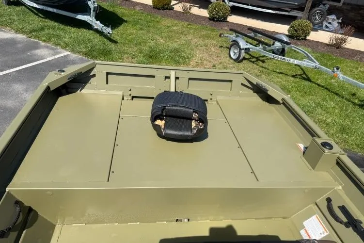 Slide: The Image of 2026 Crestliner 1870 Retriever FCC boat interior with seating, parked on grass. - 10