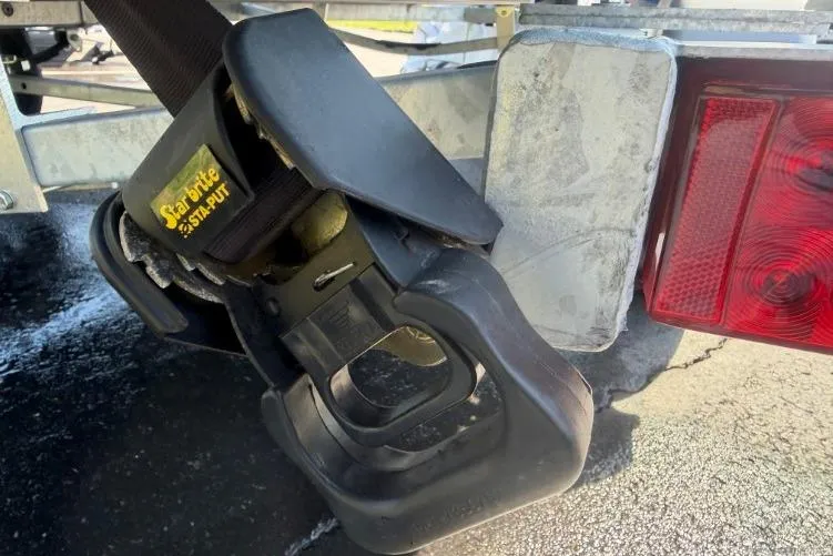 Slide: The Image of Trailer hitch of a 2026 Crestliner 1870 Retriever FCC with a secure strap mechanism. - 3