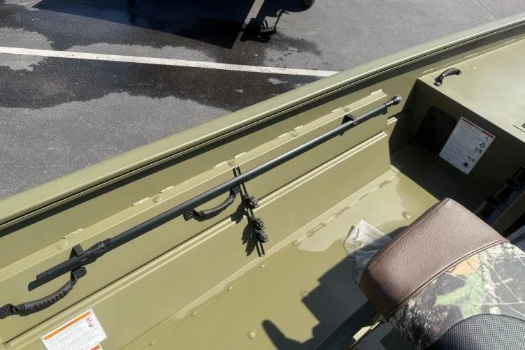 Slide: The Image of 2026 Crestliner 1870 Retriever FCC boat interior with rod holder and camo seat. - 9