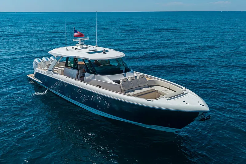 Slide: The Image of 2024 Tiara Yachts 48 LS luxury boat cruising on open ocean waters. - 1