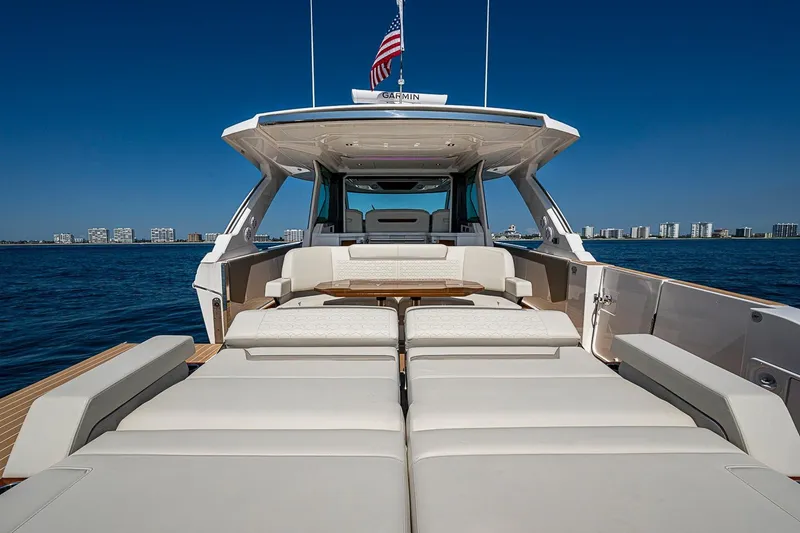 Slide: The Image of 2024 Tiara Yachts 48 LS luxury yacht with spacious deck and seating, ocean backdrop. - 10