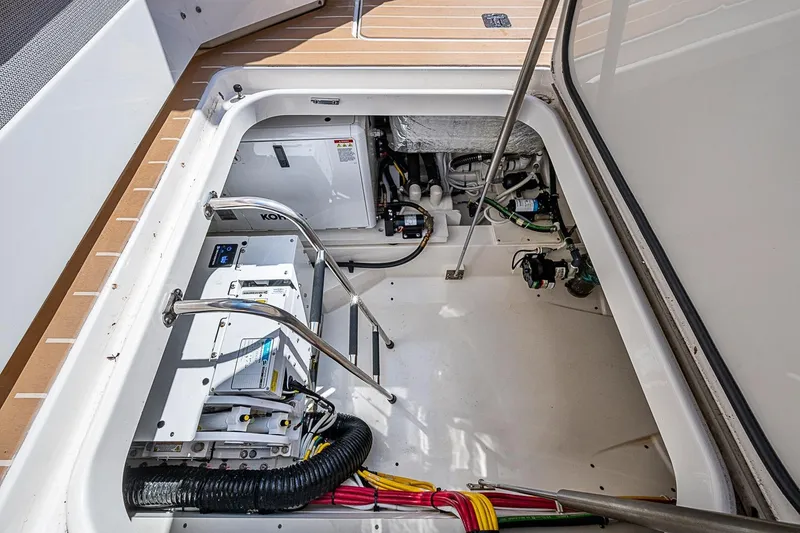 Slide: The Image of 2024 Tiara Yachts 48 LS engine compartment with equipment and wiring. - 16