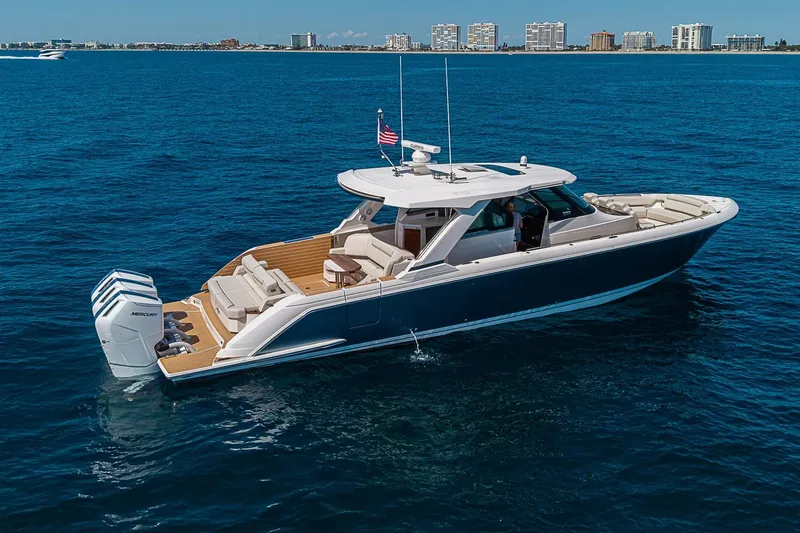 Slide: The Image of 2024 Tiara Yachts 48 LS luxury boat cruising on open water. - 2