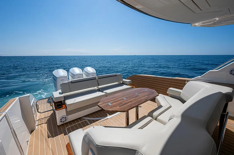 Slide: The Image of 2024 Tiara Yachts 48 LS luxury yacht deck with seating and ocean view. - 22