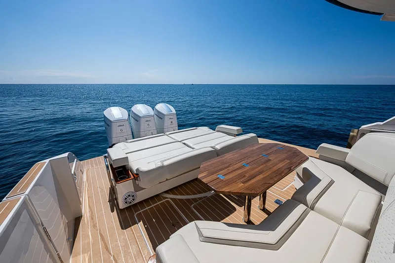 Slide: The Image of Luxurious 2024 Tiara Yachts 48 LS with spacious deck and seating, overlooking serene ocean. - 23