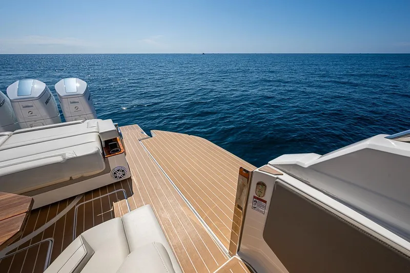 Slide: The Image of 2024 Tiara Yachts 48 LS luxury deck overlooking the ocean with outboard engines. - 24