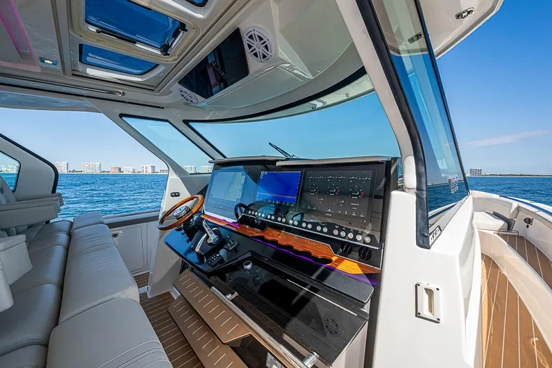 Slide: The Image of 2024 Tiara Yachts 48 LS helm with modern controls and ocean view. - 29