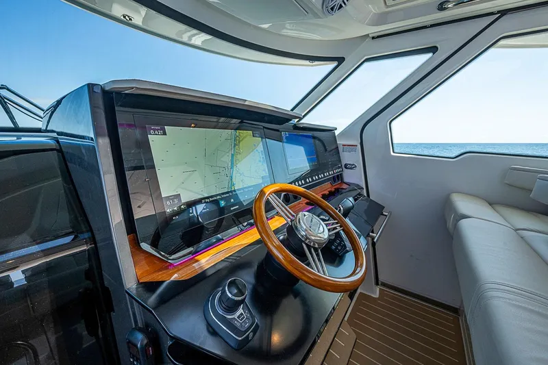 Slide: The Image of 2024 Tiara Yachts 48 LS helm with advanced navigation system and luxurious seating. - 31