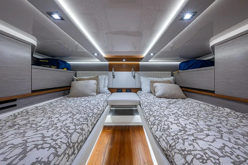 Slide: The Image of Luxurious 2024 Tiara Yachts 48 LS cabin interior with twin beds and modern lighting. - 35