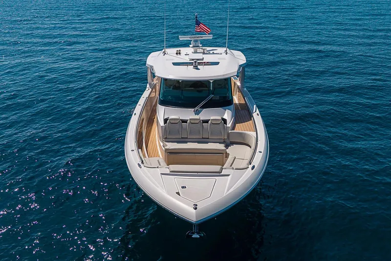 Slide: The Image of 2024 Tiara Yachts 48 LS luxury boat on open water, front view. - 5
