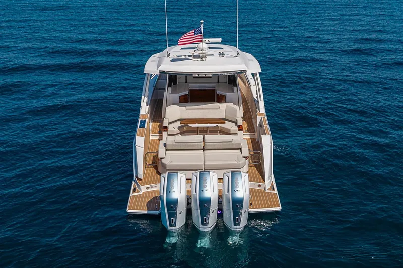 Slide: The Image of 2024 Tiara Yachts 48 LS luxury boat with triple engines on open sea. - 6