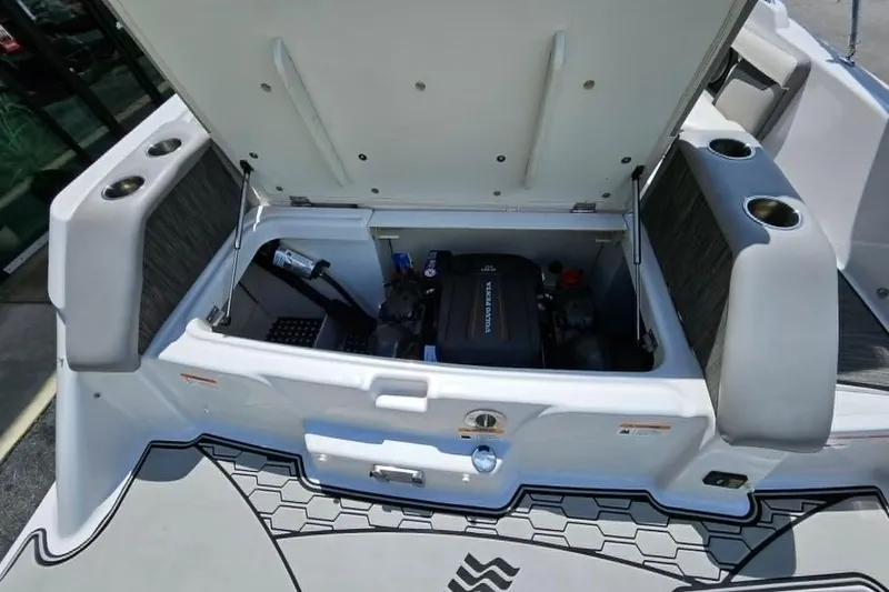 Slide: The Image of 2019 Four Winns HD220 boat engine compartment with open hatch, showcasing interior components. - 10