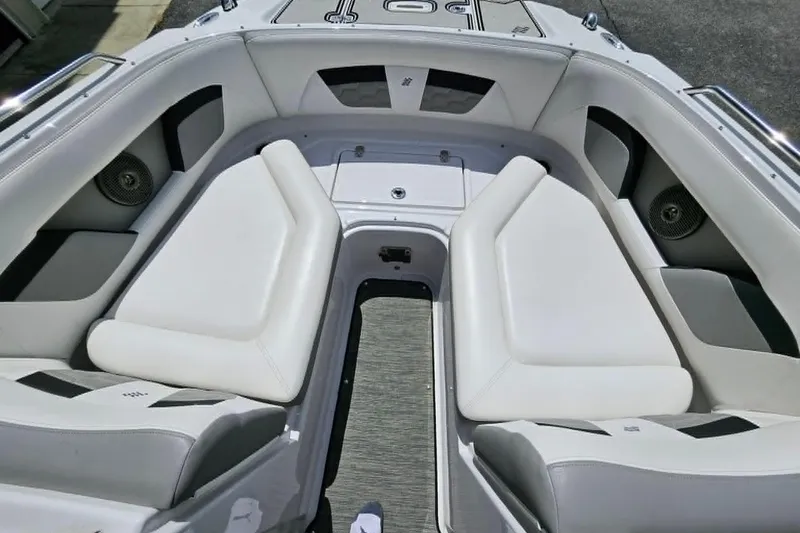Slide: The Image of 2019 Four Winns HD220 boat interior with white cushioned seating and speakers. - 14