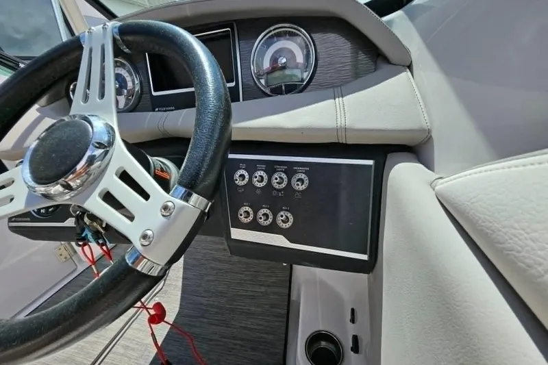 Slide: The Image of 2019 Four Winns HD220 boat dashboard with steering wheel and control panel. - 17