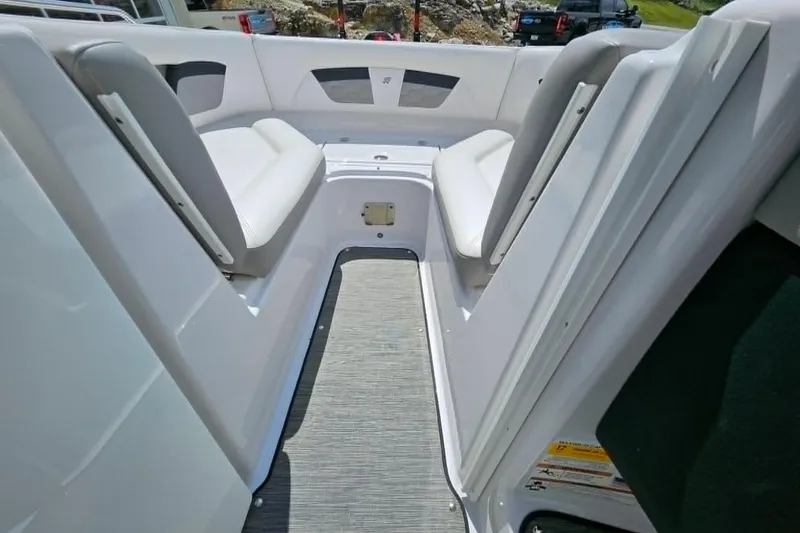 Slide: The Image of 2019 Four Winns HD220 boat interior with white seating and gray flooring. - 18