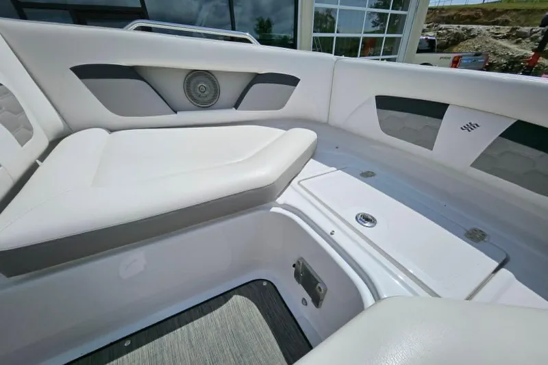 Slide: The Image of 2019 Four Winns HD220 boat interior with white cushioned seating and speaker. - 22