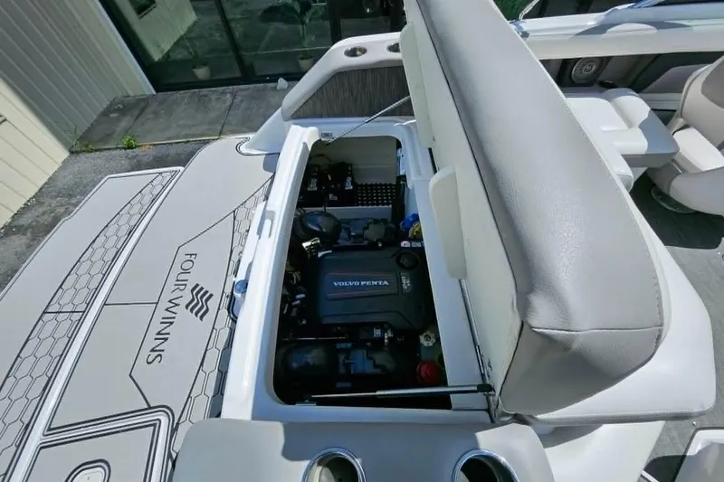 Slide: The Image of 2019 Four Winns HD220 boat engine compartment with Volvo Penta engine visible. - 24
