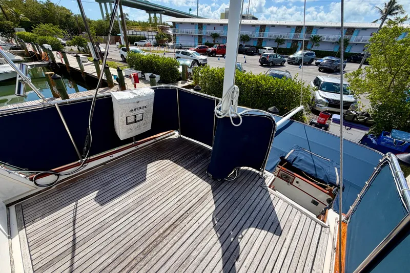 Slide: The Image of 1983 Grand Banks 32 Sedan boat deck with wooden flooring and blue rail covers. - 18