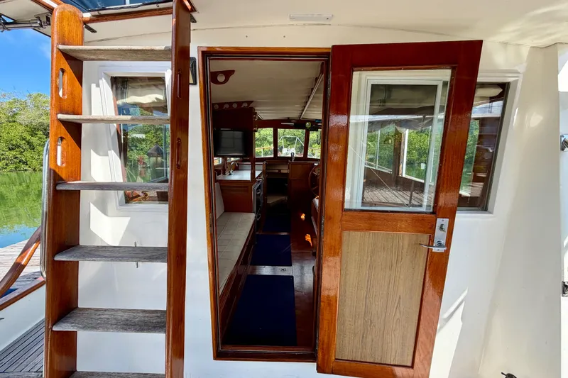 Slide: The Image of 1983 Grand Banks 32 Sedan interior view with wooden stairs and door. - 22