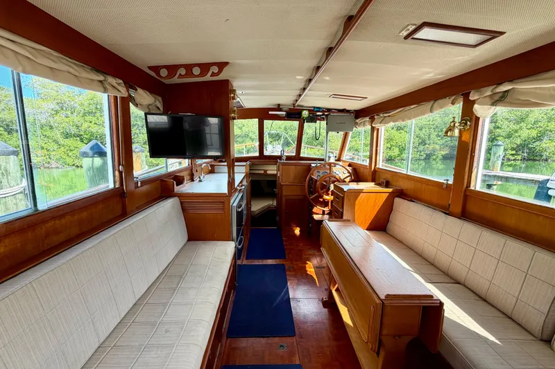 Slide: The Image of Interior of 1983 Grand Banks 32 Sedan boat with wood finish and seating. - 23