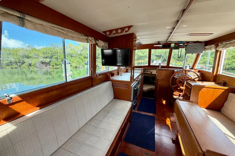 Slide: The Image of Interior of 1983 Grand Banks 32 Sedan boat with wooden furnishings and scenic window views. - 24
