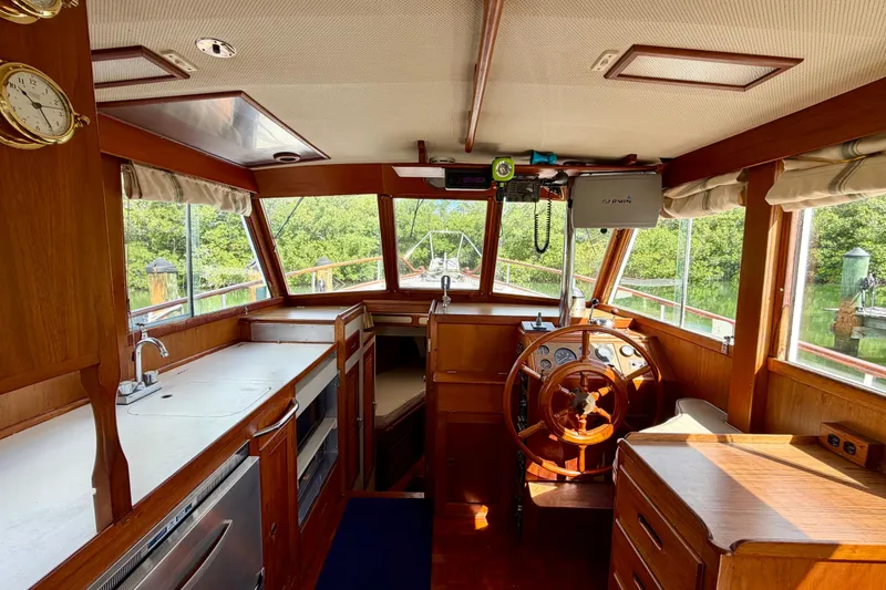 Slide: The Image of Interior of 1983 Grand Banks 32 Sedan boat with wooden helm and kitchen area. - 25