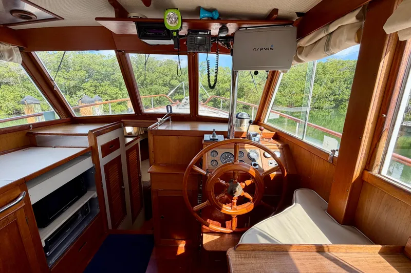 Slide: The Image of Interior of 1983 Grand Banks 32 Sedan boat with wooden helm and navigation equipment. - 26