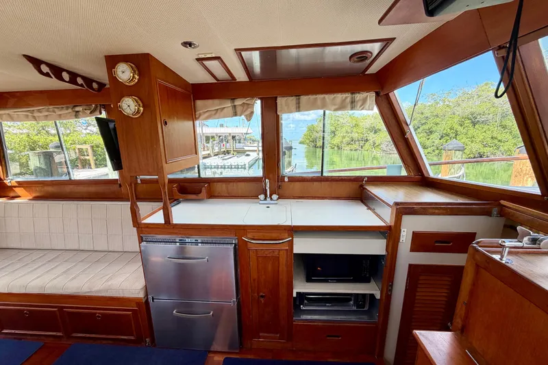 Slide: The Image of Interior of a 1983 Grand Banks 32 Sedan boat with wood finish and kitchen amenities. - 29