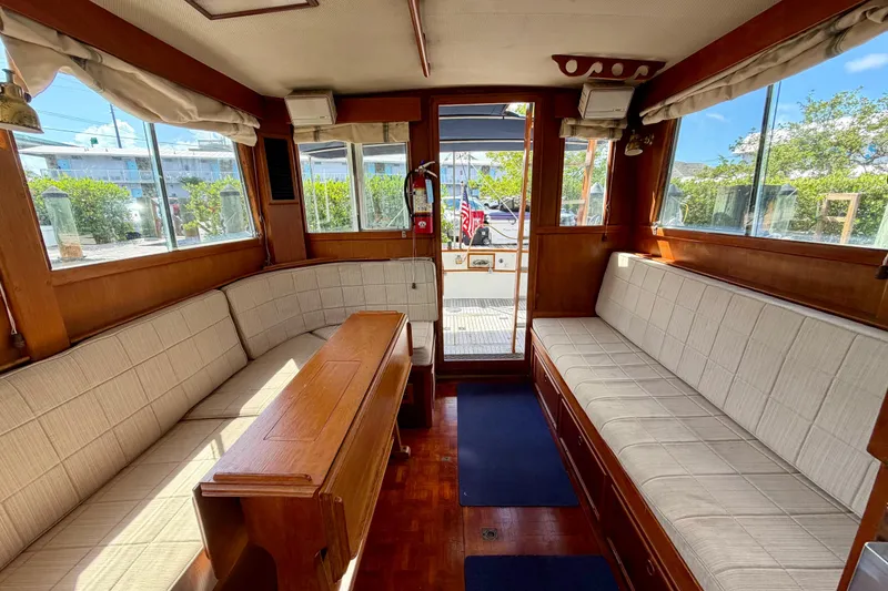 Slide: The Image of Interior of 1983 Grand Banks 32 Sedan with wooden furnishings and cushioned seating. - 32