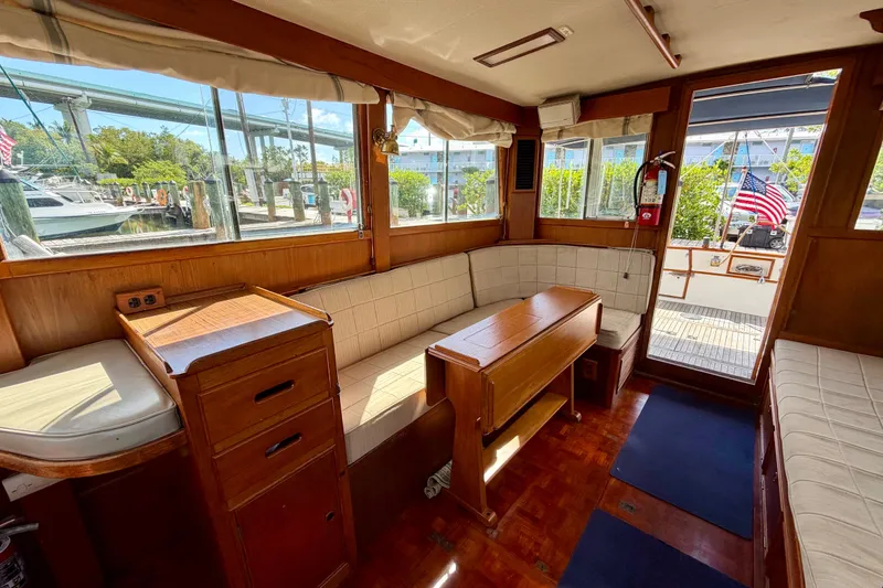 Slide: The Image of Interior of a 1983 Grand Banks 32 Sedan boat with wooden furnishings and seating. - 33
