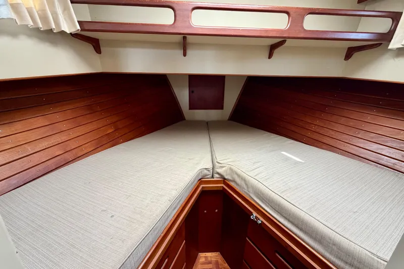 Slide: The Image of Interior cabin of 1983 Grand Banks 32 Sedan with wooden paneling and cushioned berth. - 38