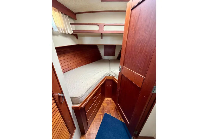 Slide: The Image of Cozy cabin interior of 1983 Grand Banks 32 Sedan with wooden furnishings and bed. - 46