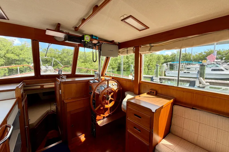 Slide: The Image of Interior of a 1983 Grand Banks 32 Sedan boat with wooden helm and seating. - 47