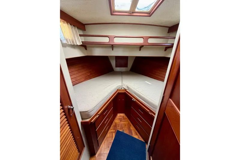 Slide: The Image of Cozy cabin interior of 1983 Grand Banks 32 Sedan with wooden furnishings and bedding. - 48