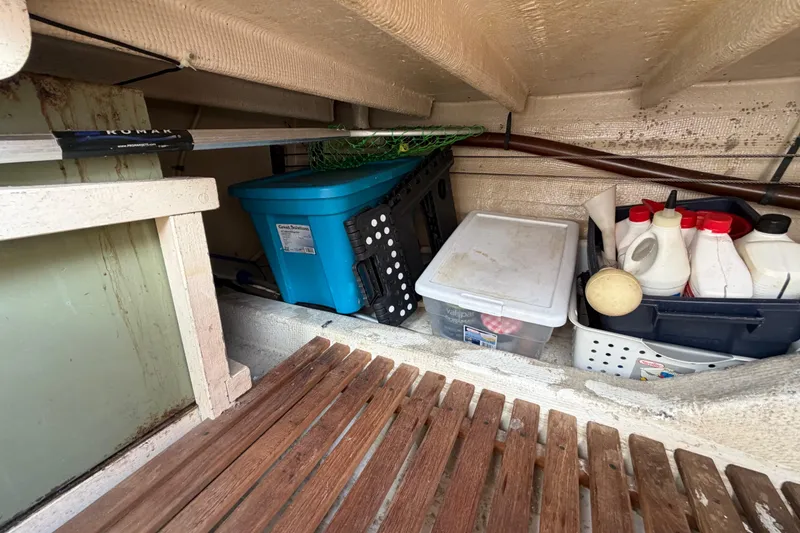 Slide: The Image of Storage area on a 1983 Grand Banks 32 Sedan with containers and maintenance supplies. - 54