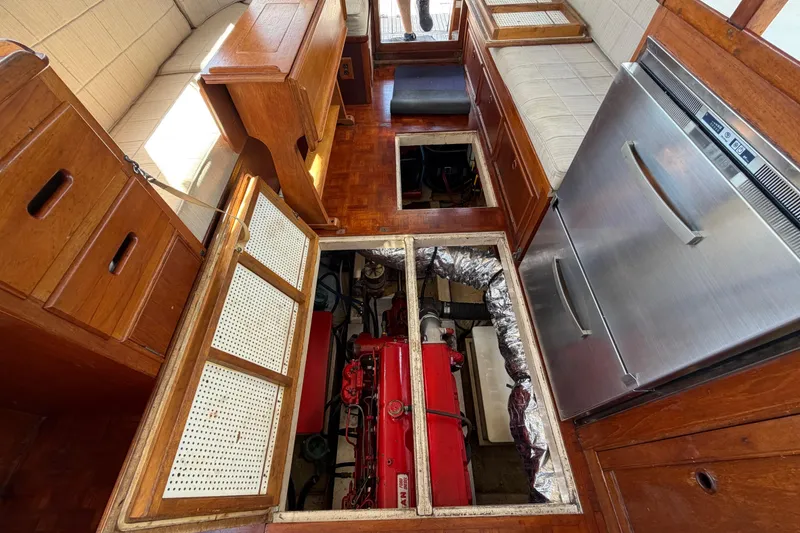 Slide: The Image of Interior of a 1983 Grand Banks 32 Sedan showing engine compartment and wooden cabinetry. - 56