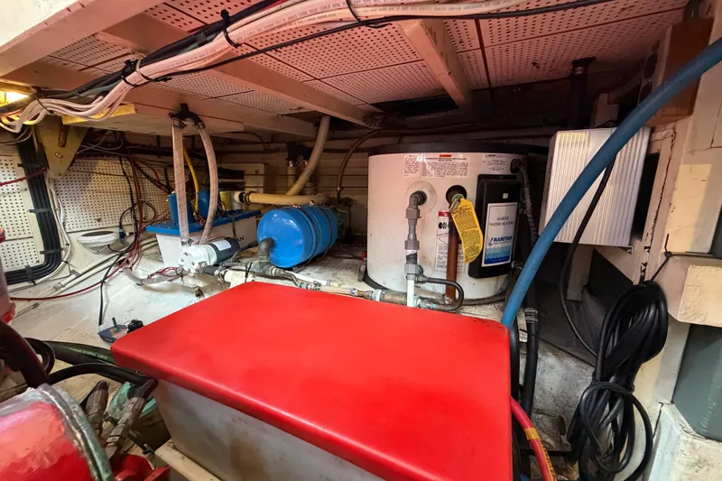 Slide: The Image of Engine room of 1983 Grand Banks 32 Sedan with water heater and wiring. - 59
