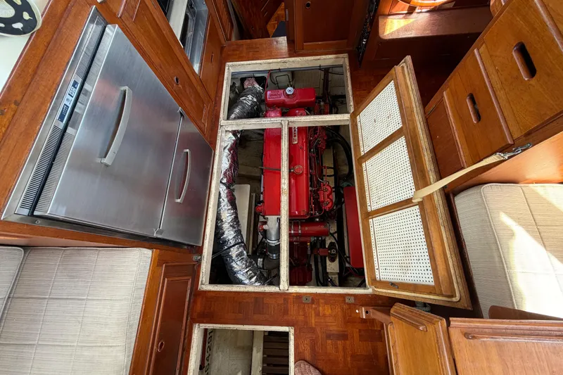 Slide: The Image of Engine room of 1983 Grand Banks 32 Sedan with red engine and wooden cabinetry. - 62