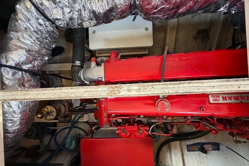 Slide: The Image of Engine compartment of a 1983 Grand Banks 32 Sedan with red Ford Lehman diesel engine. - 64