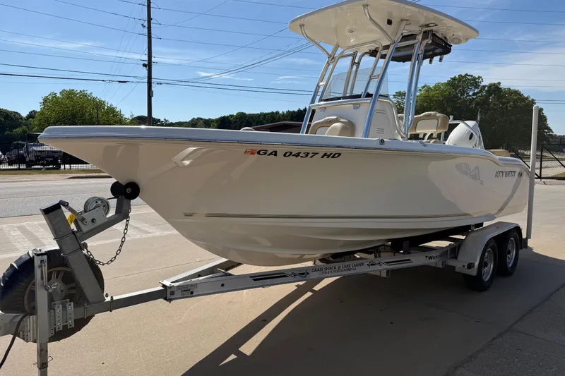 Slide: The Image of 2017 Key West 219 FS boat on trailer, parked outdoors in sunny weather. - 13
